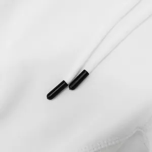 Macro view of white braided drawstring with sleek black aglets on sports shorts