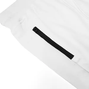 Detailed close-up of the black side zipper pocket on white men's cotton athletic shorts.