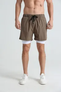 Men's double-layer quick-dry gym sports shorts in brown with white lining on model