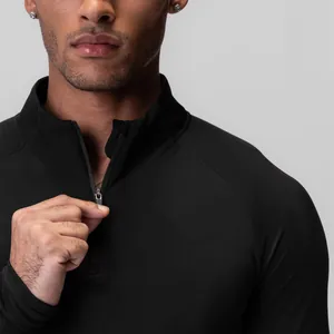 Professional close-up of black men's compression long sleeve top with half-zip detail