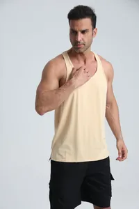 Close-up detail of men's pale yellow athletic tank top for gym and outdoor fitness.