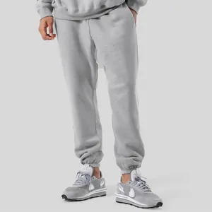 Grey unisex fleece-lined joggers with loose fit and elastic cuffs for winter.