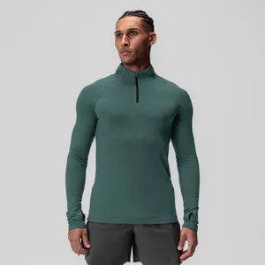 Men's athletic half-zip compression long sleeve shirt with thumbholes in forest green.