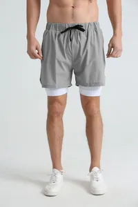 Front view of men's athletic 2-in-1 grey running shorts with white compression liner.