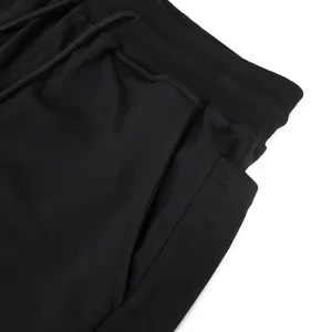 Close-up of black men's breathable cotton sports shorts with elastic waistband detail