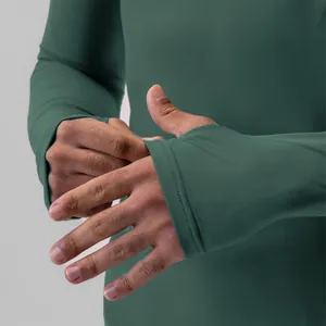 Detail view of green men's athletic compression shirt with functional thumbholes