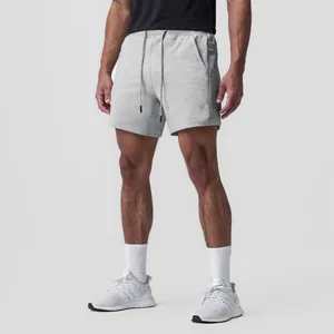 Detailed view of men's grey breathable cotton athletic shorts featuring side pockets