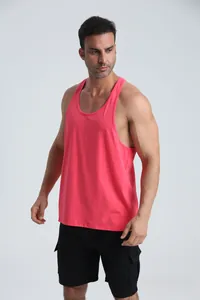 Muscular male model wearing a breathable pink sports racerback tank top in a studio setting