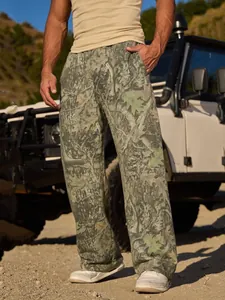 Close-up of men's loose jogging pants featuring a digital forest camouflage pattern