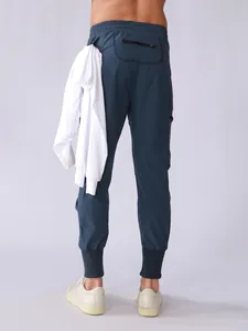Back view of men's navy quick-dry sports joggers with multi-pocket cargo design