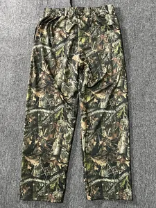 Detailed view of men's loose joggers featuring a realistic digital forest camo pattern