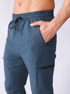 Close-up detail of men's quick-dry athletic cargo pants with elastic drawstring waist.