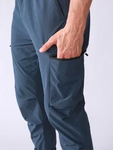 Detailed close-up view of the side zipper cargo pocket on men's blue quick-dry sport pants.