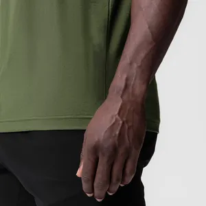 Close-up detail of green athletic tank top showing wide armhole and fabric texture