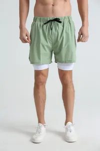 Detail view of men's olive 2-in-1 sports shorts featuring white compression liner