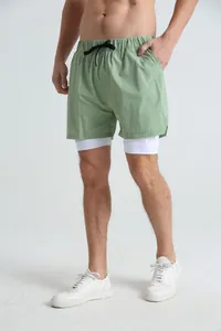 Close-up detail of men's double-layer sage green fitness shorts with inner lining