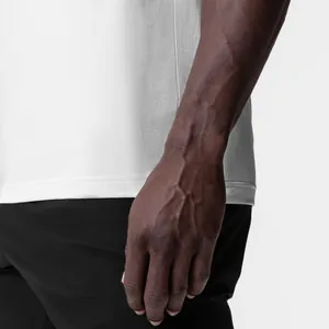 Detail of white cotton-blend fitness tank top for men showing armhole and fabric texture