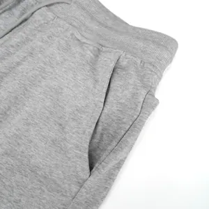 Detail of pocket and breathable heather grey cotton fabric on men's athletic shorts.