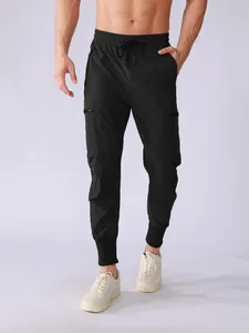 Detailed view of men's quick-dry black cargo joggers with multi-pockets and drawstring