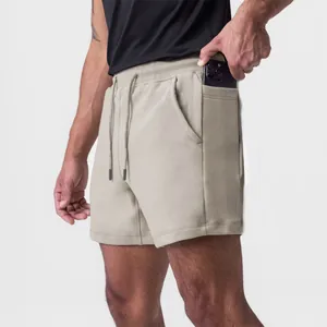 Detailed view of khaki men's athletic shorts featuring a functional side phone pocket