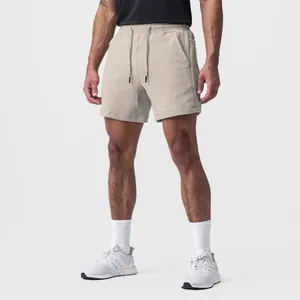 Full view of khaki men's athletic shorts made of breathable cotton fabric on model