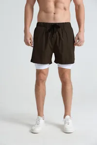 Detail shot of men's double-layered running shorts with elastic waist and brown finish