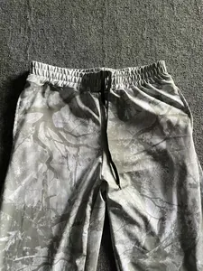 Close-up of men's digital forest camo jogger pants with elastic drawstring waist