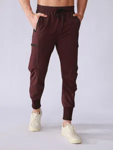 Detail view of men's burgundy quick-dry cargo pants with multi-pockets and tapered cuffs.