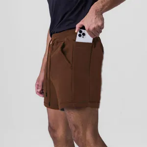 Close-up of men's brown athletic sports shorts with a functional side phone pocket