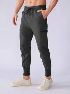 Detail shot of men's charcoal grey quick-dry athletic cargo joggers with pockets