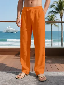 Close-up detail of men's breathable orange linen pants featuring a drawstring waist