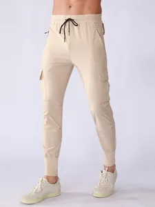 Men's beige quick-dry athletic cargo pants with multi-pocket design and ribbed cuffs