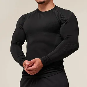 Macro view of black tight-fitting long-sleeved athletic t-shirt with mesh texture details