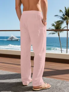 Back view of men's loose pink linen casual trousers for a summer resort vacation