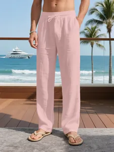 Close-up of men's breathable pink linen pants with drawstring for beach vacation.