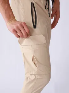 Close-up of functional multi-pocket design on men's quick-dry khaki cargo pants.