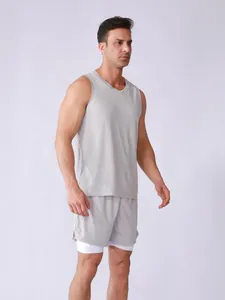 Male model wearing a light grey breathable mesh tank top and double-layered shorts