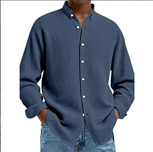 Close-up of blue waffle knit texture on men's casual button-down long-sleeve shirt