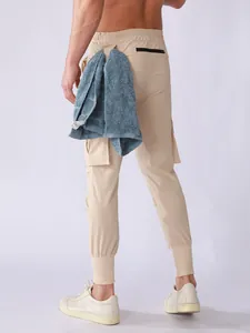 Back view of men's beige quick-dry joggers with pockets and towel loop detail.