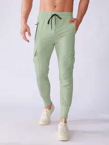 Detail view of men's light green quick-dry cargo pants with drawstring and pockets