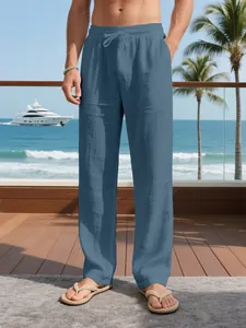 Detail of men's breathable blue linen straight-leg trousers with drawstring in a resort setting