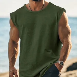 Detailed view of olive green muscle tank top with raw edge hem and cotton texture