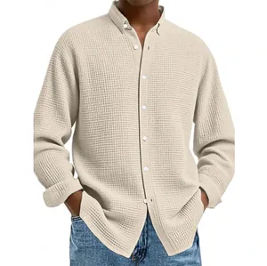 Macro view of beige waffle knit texture on this men's casual long-sleeve shirt.