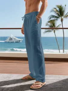 Close-up of men's blue breathable linen trousers with a drawstring waist for resort wear