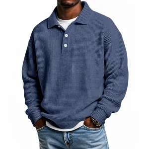 Close-up detail of blue waffle-knit texture on a men's vintage-style loose-fit polo shirt
