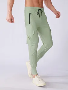 Detailed view of men's mint green quick-dry cargo joggers with drawstring waist