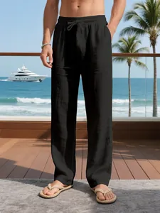 Close-up of black breathable loose linen pants for men with drawstring waist at beach