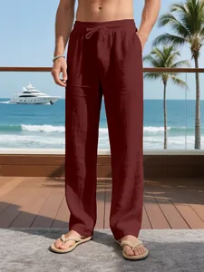 Macro detail of men's maroon linen trousers featuring a comfortable drawstring waist.