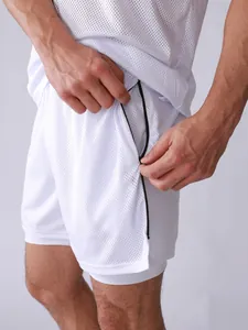 Detail view of white mesh athletic shorts featuring a functional black zipper pocket.