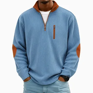 Detailed view of men's blue ribbed corduroy half-zip sweatshirt featuring brown elbow patches